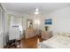 This light and airy bedroom has neutral walls, beautiful wood floors, and a modern ceiling fan at 603 Yorkshire Dr, Oviedo, FL 32765