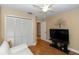 Bedroom features a large closet, a television, and a comfortable white sofa at 603 Yorkshire Dr, Oviedo, FL 32765