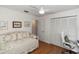 Cozy bedroom features a comfortable daybed, wood floors, closet, and a white ceiling fan at 603 Yorkshire Dr, Oviedo, FL 32765