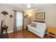 Cozy bedroom with light walls, wood floors, a white sofa and a map at 603 Yorkshire Dr, Oviedo, FL 32765