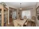 Formal dining room with wood flooring, a chandelier, and large windows draped in sheer curtains at 603 Yorkshire Dr, Oviedo, FL 32765