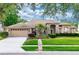 Charming single-story brick home with a well-manicured lawn and mature landscaping, offering great curb appeal at 603 Yorkshire Dr, Oviedo, FL 32765