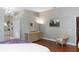 Side view of the main bedroom featuring wood floors, dresser, mirror, and accent chair at 603 Yorkshire Dr, Oviedo, FL 32765