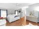 Light-filled main bedroom featuring wood floors, a comfortable king-sized bed, and a mirrored dresser at 603 Yorkshire Dr, Oviedo, FL 32765