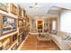 Charming sitting room featuring hardwood floors, extensive art, and comfortable sofa seating at 603 Yorkshire Dr, Oviedo, FL 32765