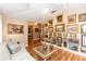 Inviting sitting room with custom art display, featuring hardwood floors, track lighting, and comfortable seating at 603 Yorkshire Dr, Oviedo, FL 32765
