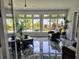Bright sunroom with large windows overlooking lush landscaping and stylish wicker furniture at 603 Yorkshire Dr, Oviedo, FL 32765