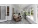 This sunroom offers lots of natural light, tile flooring, and cozy seating at 603 Yorkshire Dr, Oviedo, FL 32765