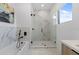Modern bathroom featuring marble floors, a soaking tub and a glass walk-in shower at 6454 Chorus Dr, Mascotte, FL 34753