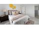 Bedroom with white walls, neutral decor, and decorative golden wall decor at 6454 Chorus Dr, Mascotte, FL 34753