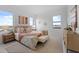 Bright bedroom featuring two large windows, neutral decor, a bench, and wood floors at 6454 Chorus Dr, Mascotte, FL 34753