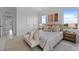 Well-lit bedroom with a large window, neutral decor, and a bench seat at 6454 Chorus Dr, Mascotte, FL 34753