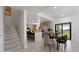 Open-concept dining area and kitchen with modern appliances, sleek countertops, and a seamless flow for entertaining at 6454 Chorus Dr, Mascotte, FL 34753