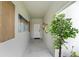 Bright foyer with neutral walls, decorative mirrors, artwork, and a decorative potted tree at 6454 Chorus Dr, Mascotte, FL 34753