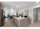 Modern kitchen with island, stainless appliances and breakfast bar overlooking living area at 6454 Chorus Dr, Mascotte, FL 34753