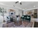 Open concept living space with contemporary furnishings and view of kitchen and dining area at 6454 Chorus Dr, Mascotte, FL 34753