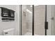 Close-up of a modern bathroom with a shower featuring sleek glass and neutral tiling at 6678 Juneberry Way, Winter Garden, FL 34787