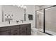 Modern bathroom featuring a double vanity with black fixtures, a black framed shower, and neutral paint at 6678 Juneberry Way, Winter Garden, FL 34787
