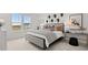 Modern primary bedroom with plush carpeting, contemporary décor, and large windows offering scenic views at 6678 Juneberry Way, Winter Garden, FL 34787