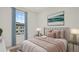 Well-lit bedroom with soft tones, stylish bed, and bright window at 6678 Juneberry Way, Winter Garden, FL 34787