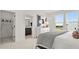 Bright bedroom with ensuite bathroom featuring a large window, neutral paint, and modern fixtures at 6678 Juneberry Way, Winter Garden, FL 34787