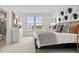 Stylish bedroom featuring bright light from a window, a decorative headboard, and a modern art design at 6678 Juneberry Way, Winter Garden, FL 34787