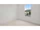 Bright, simple bedroom with white walls and a view from the window at 6678 Juneberry Way, Winter Garden, FL 34787