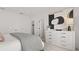 Bedroom with a large dresser, modern artwork, plush carpet, and access to an ensuite bathroom and closet at 6678 Juneberry Way, Winter Garden, FL 34787