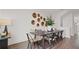 A modern dining area showcases a wooden table with stylish seating and decorative accents for a cozy atmosphere at 6678 Juneberry Way, Winter Garden, FL 34787