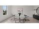 This bright dining room is furnished with a modern table, stylish chairs, and tasteful decor for elegant meals at 6678 Juneberry Way, Winter Garden, FL 34787