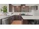 Modern kitchen features sleek stainless steel appliances, dark cabinets, a large island and modern countertops at 6678 Juneberry Way, Winter Garden, FL 34787