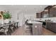 Bright kitchen with a large island, dark cabinets, stainless steel appliances, and open dining area at 6678 Juneberry Way, Winter Garden, FL 34787