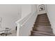 An interior staircase features wooden steps with white risers and a white railing, illuminated by natural light at 6678 Juneberry Way, Winter Garden, FL 34787