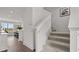 Bright foyer with a staircase and adjacent view into the dining room featuring wood floors and plentiful natural light at 6678 Juneberry Way, Winter Garden, FL 34787
