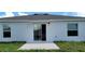 Clean back exterior with sliding glass doors that open to a spacious concrete patio at 707 Staffora St, Haines City, FL 33844