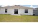 Home's backyard featuring a well-maintained lawn and a concrete patio, perfect for outdoor relaxation at 707 Staffora St, Haines City, FL 33844