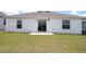 Home's backyard featuring a well-maintained lawn and a concrete patio, perfect for outdoor relaxation at 707 Staffora St, Haines City, FL 33844