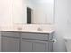 Bright bathroom features a double sink vanity, a mirror, and a glass-enclosed shower at 707 Staffora St, Haines City, FL 33844