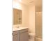 Well-lit bathroom features a single sink vanity, a mirror, and a glass-enclosed shower at 707 Staffora St, Haines City, FL 33844