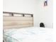 Bedroom featuring a bed with a fabric headboard and a nightstand with a fan at 707 Staffora St, Haines City, FL 33844