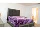 Bright bedroom featuring an upholstered bed and views into an ensuite bathroom at 707 Staffora St, Haines City, FL 33844