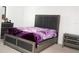 Comfortable bedroom features an upholstered bed, matching nightstands, and neutral carpet at 707 Staffora St, Haines City, FL 33844