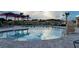 A view of the relaxing community pool featuring clear water, lounge chairs, and shade canopies at 707 Staffora St, Haines City, FL 33844