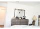 A stylish dresser and mirror combo create a functional and aesthetically pleasing focal point at 707 Staffora St, Haines City, FL 33844