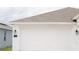 The garage door in white complements the home's exterior, offering secure parking at 707 Staffora St, Haines City, FL 33844