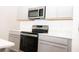 Modern kitchen featuring a stainless steel oven and ample counter space and sleek cabinetry at 707 Staffora St, Haines City, FL 33844