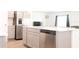 Bright kitchen featuring an island with a stainless steel dishwasher and a stainless steel refrigerator at 707 Staffora St, Haines City, FL 33844