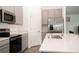 Kitchen with stainless steel appliances, light gray cabinetry, and an open floor plan at 707 Staffora St, Haines City, FL 33844