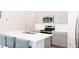 Contemporary kitchen featuring a large island, stainless steel appliances, and sleek gray cabinetry at 707 Staffora St, Haines City, FL 33844