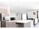 Modern kitchen with an island, stainless steel appliances, and a view of the adjacent living room at 707 Staffora St, Haines City, FL 33844